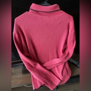 Hot pink turtleneck sweater with black trim by Emma James